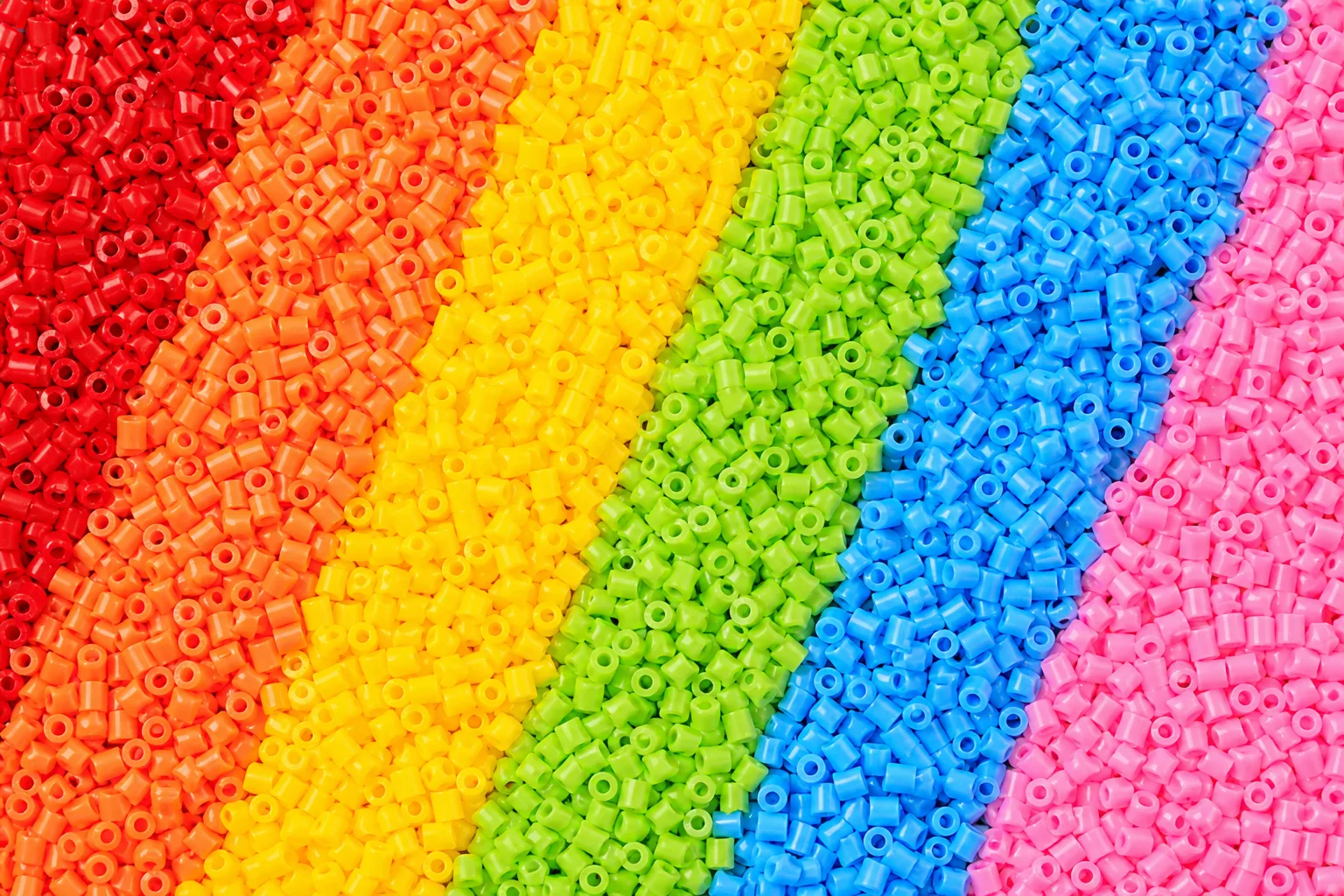 Colorful fuse beads sorted in rainbow stripes